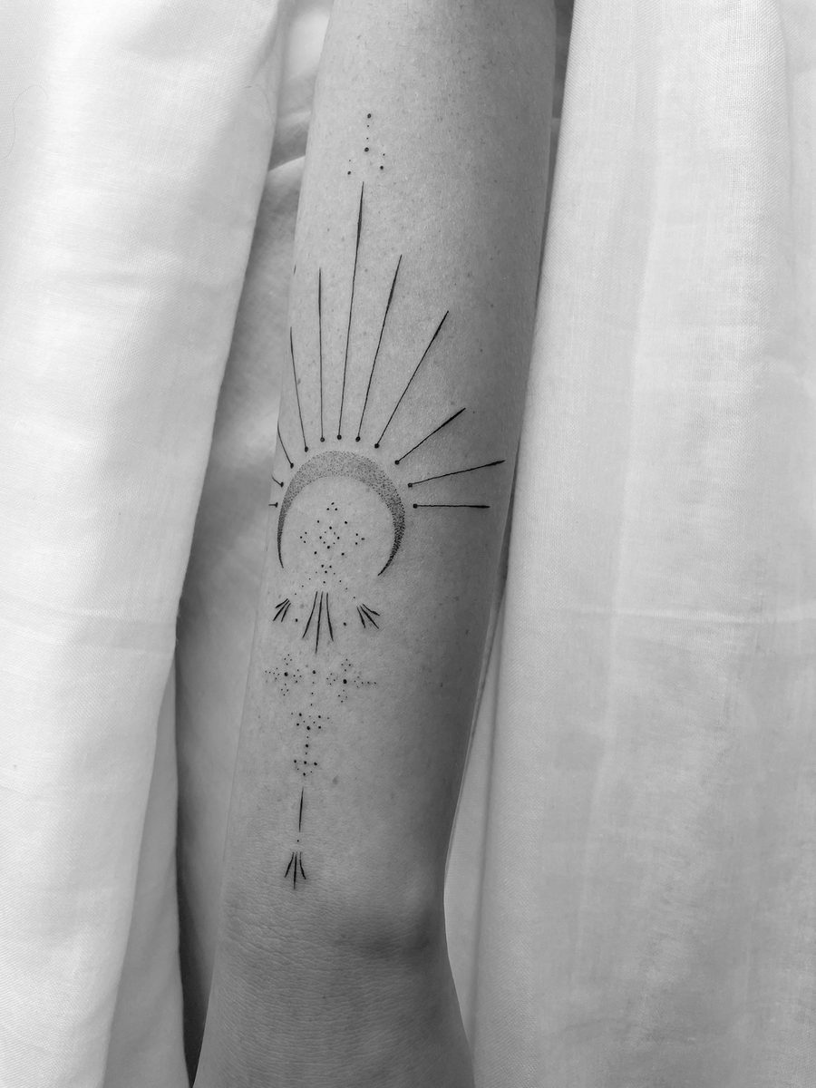 Sun and moon ornamental fine line tattoo on forearm by Caroline Lindskov