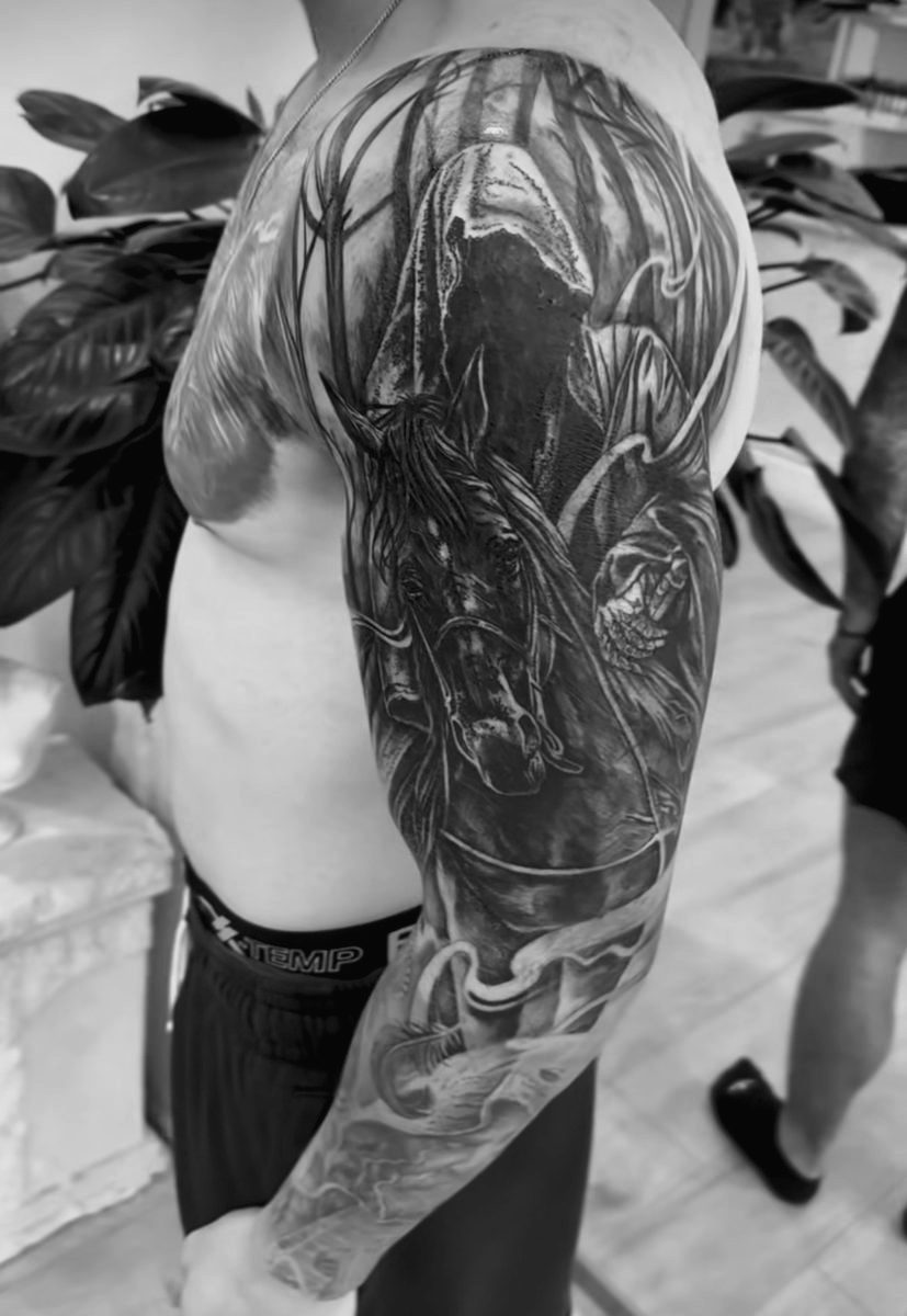 Horse and grim reaper sleeve tattoo in black and grey realism by Charlie Lund