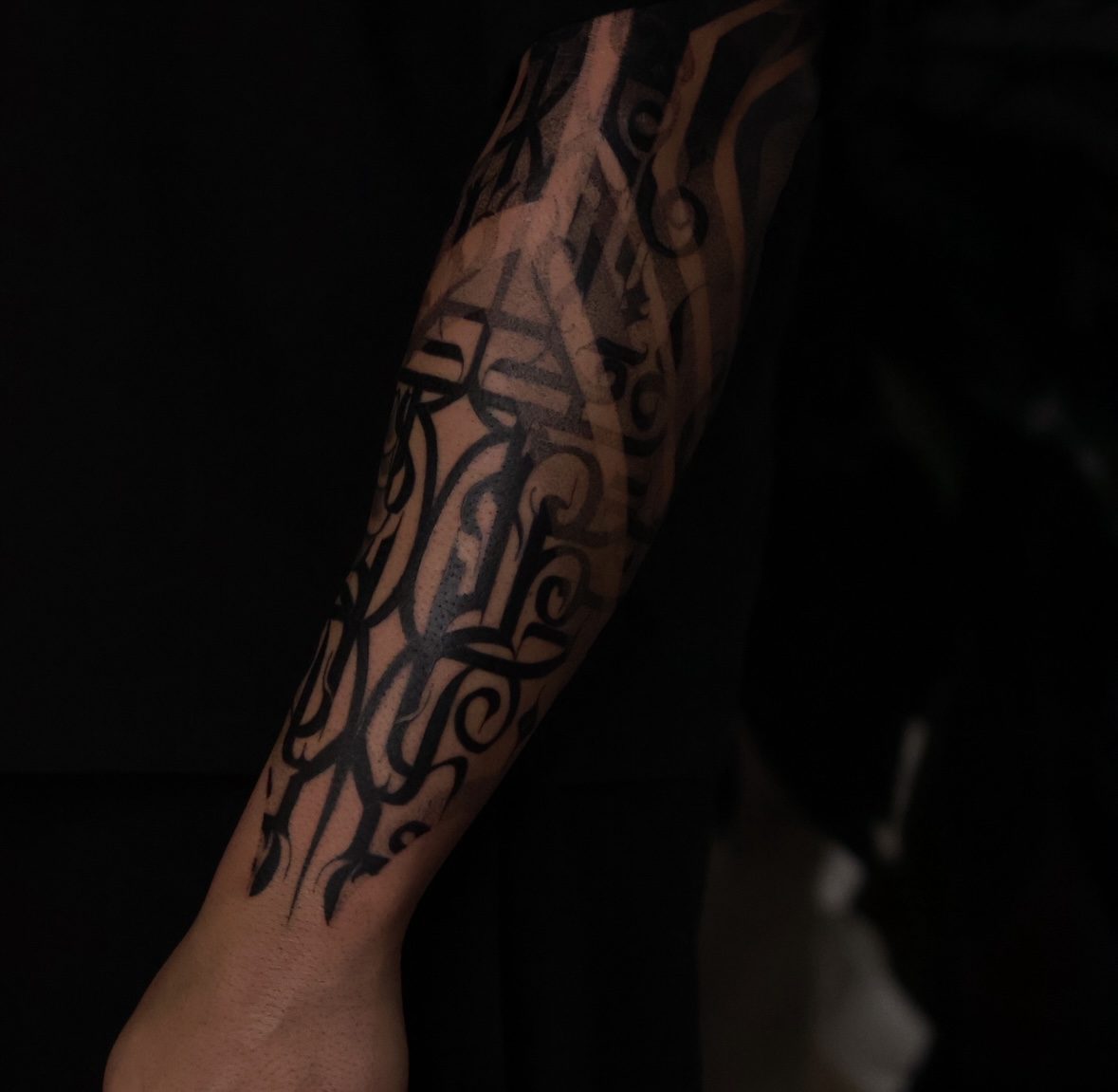Geometric ornamental sleeve tattoo on forearm by Josh Marx