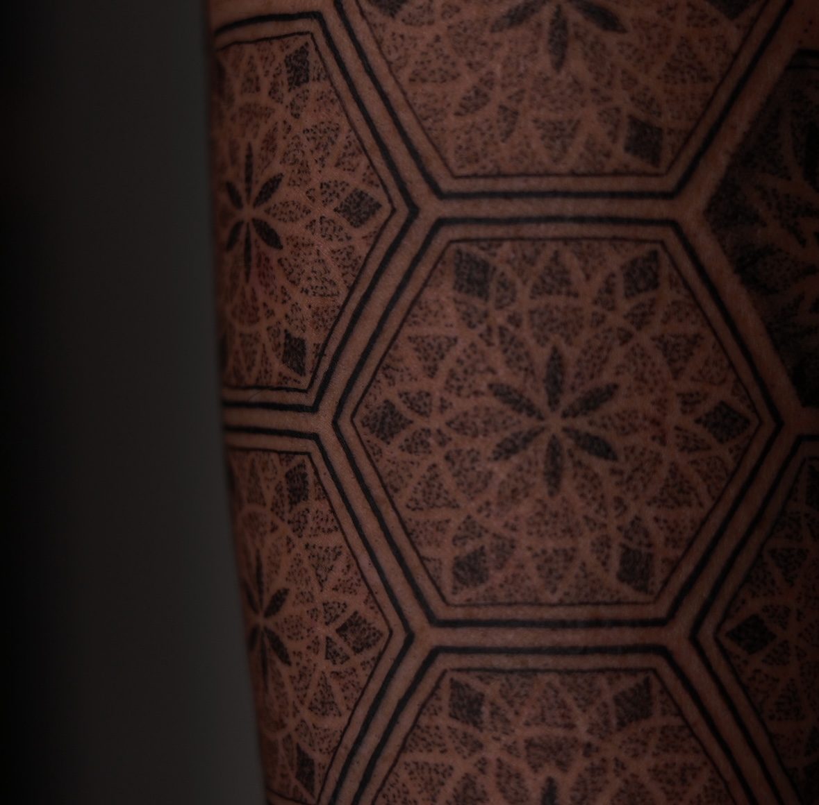 Hexagonal dotwork mandala tattoo on torso by Josh Marx