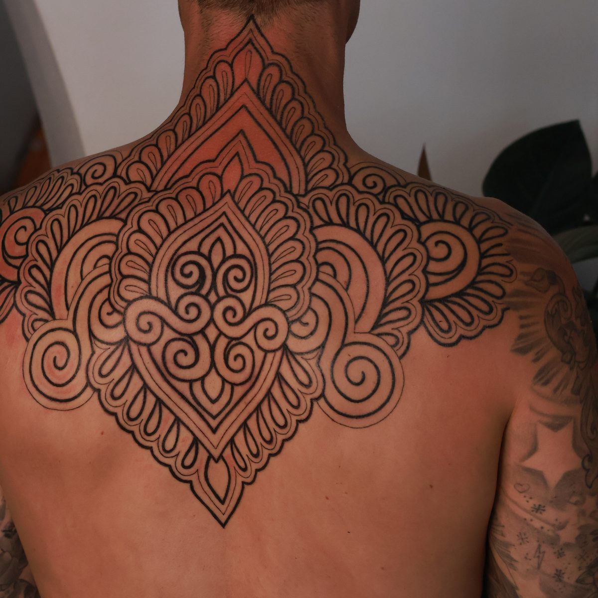 Symmetrical ornamental linework tattoo by Josh Marx